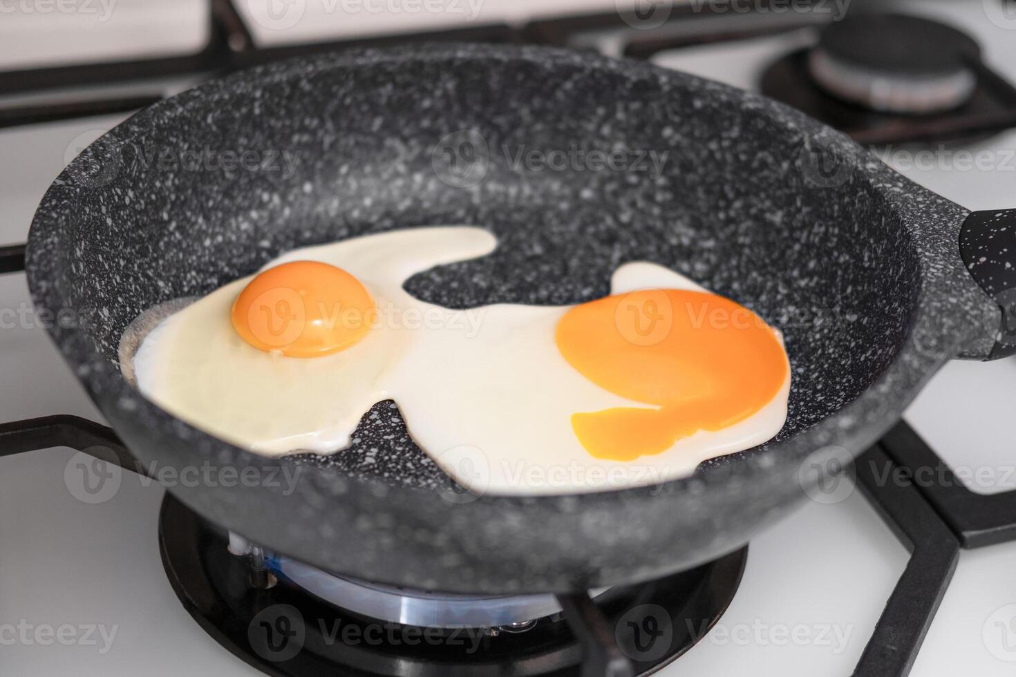 fried eggs in a frying pan close-up photo