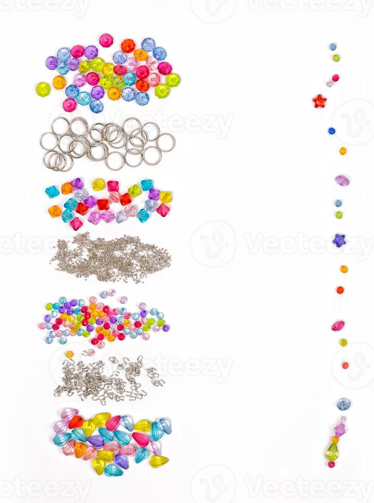 Set for design of colored beads on a white background for the signature, rings, beads, for example photo