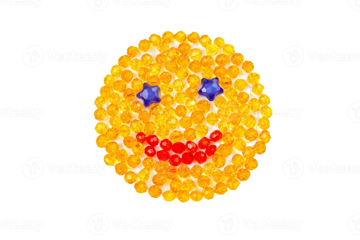 Smiling yellow smiley with beads on a white background. photo