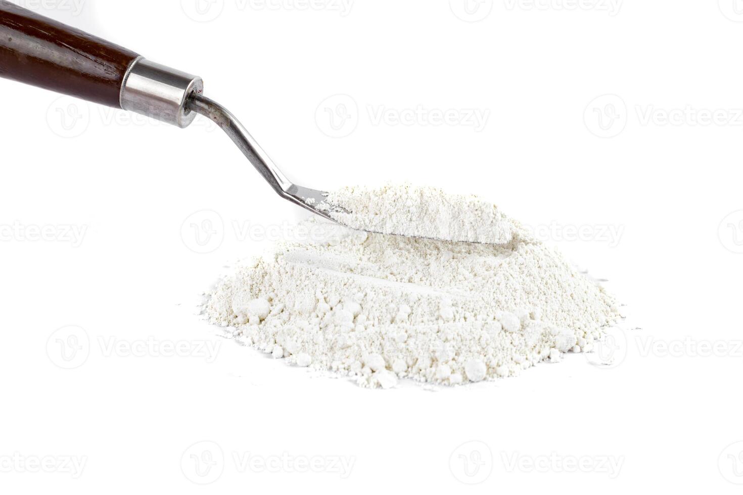 White Powder With a Metal Spatula on a Clean Surface in a Bright Setting photo