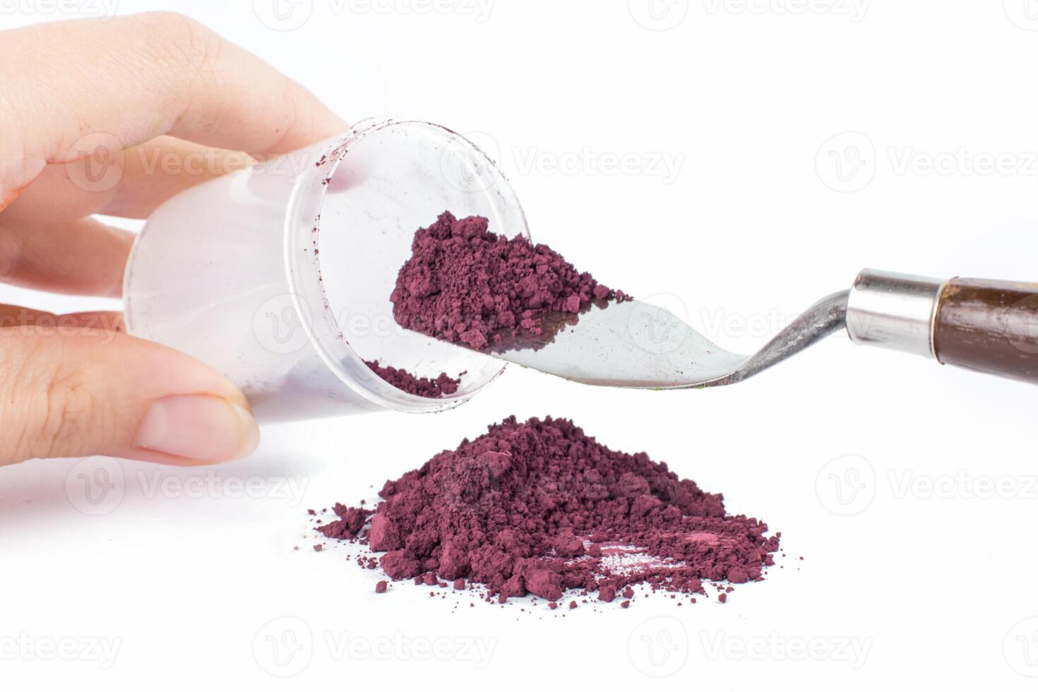 Powder Being Scooped From a Container With a Knife for Crafting or Artistic Projects photo