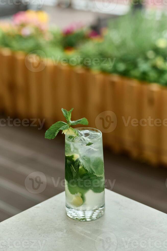 Mojito cocktail with lime and mint on table, closeup photo