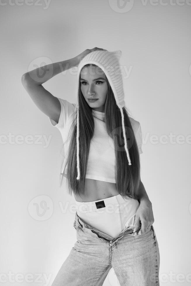Beautiful woman in a cat ear hat posing in front of a camera photo