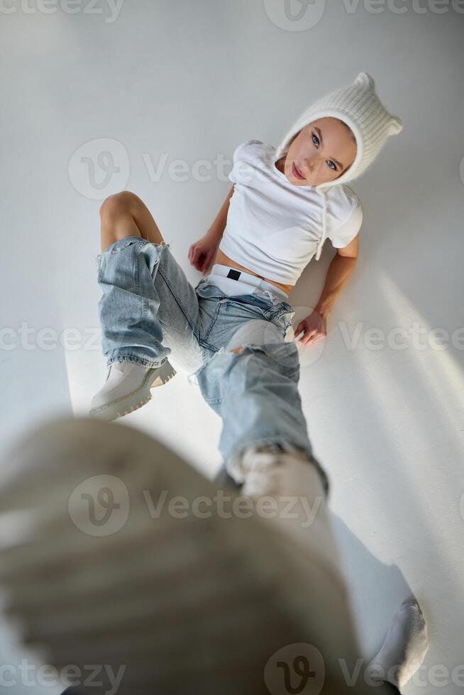 Portrait of a beautiful girl in a white T-shirt and jeans photo