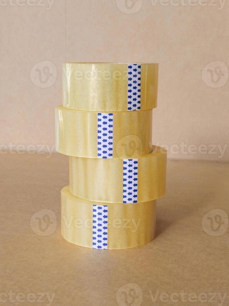 Stack of reel of scotch tape on a packing carton photo
