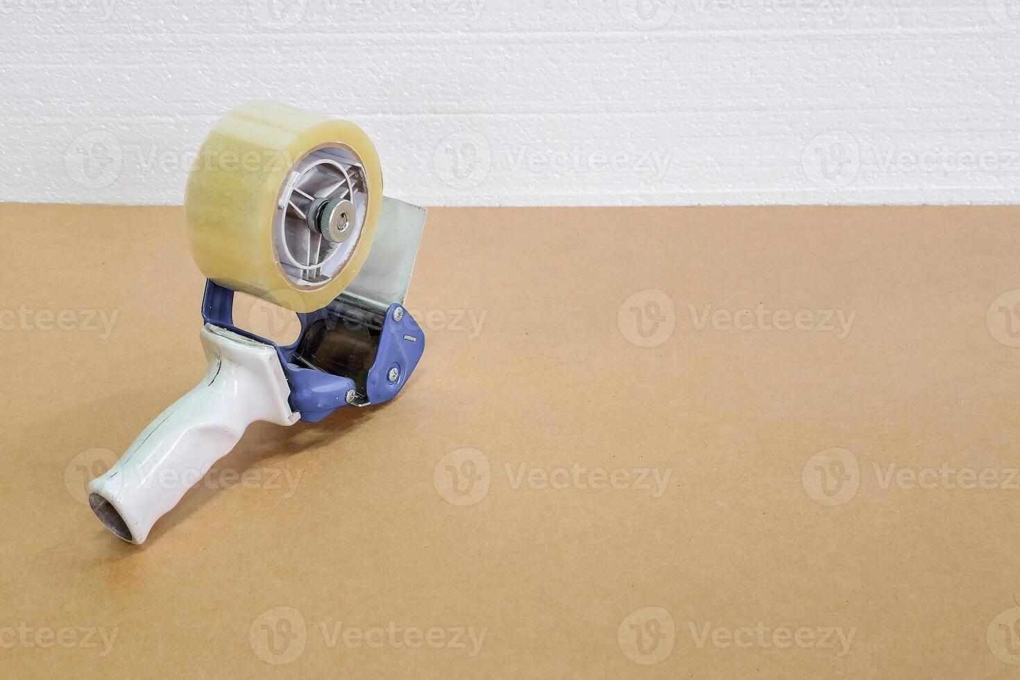scotch dispenser lies on a sheet of cardboard photo