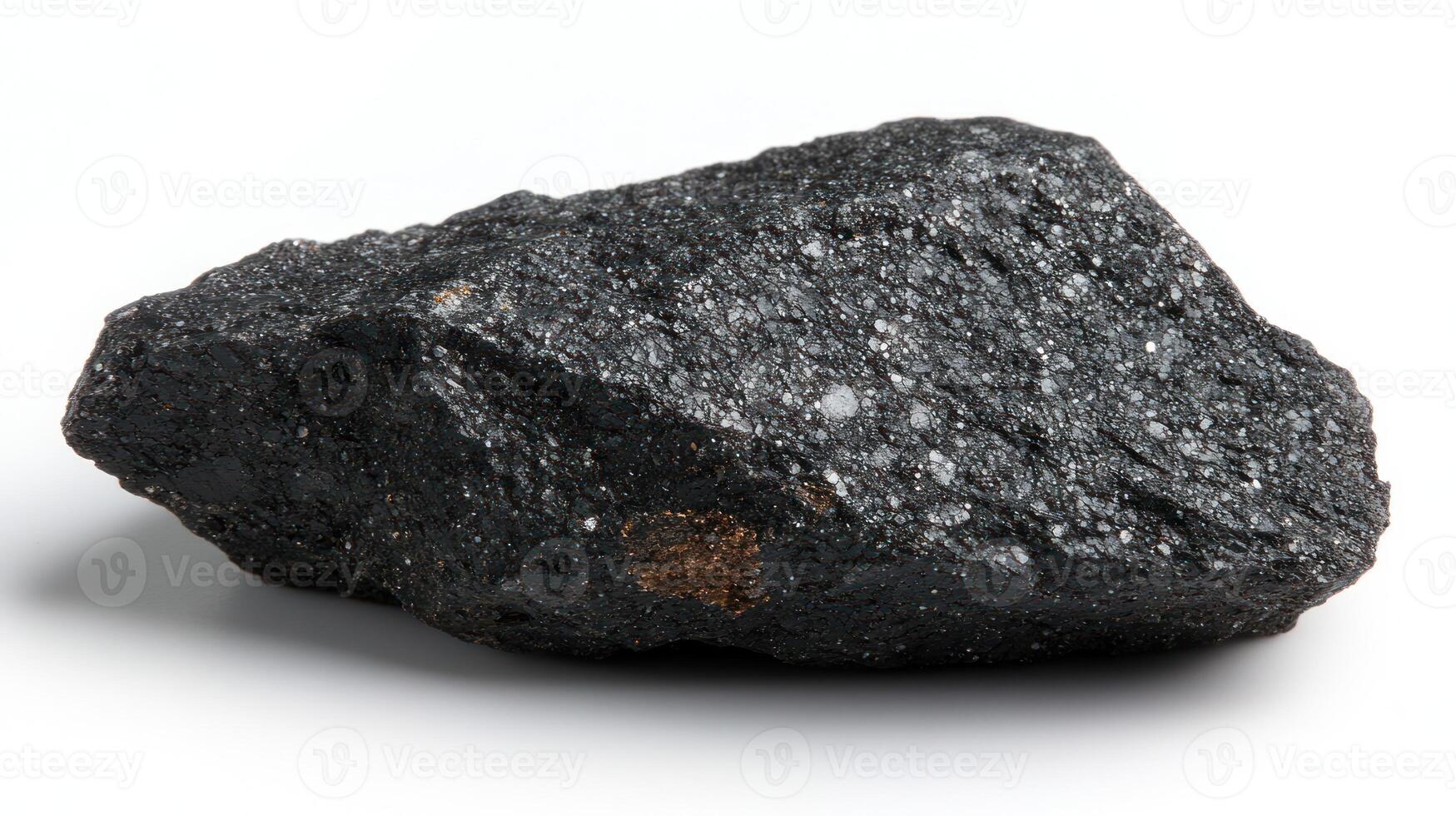 A dark, textured rock with a shiny surface. photo