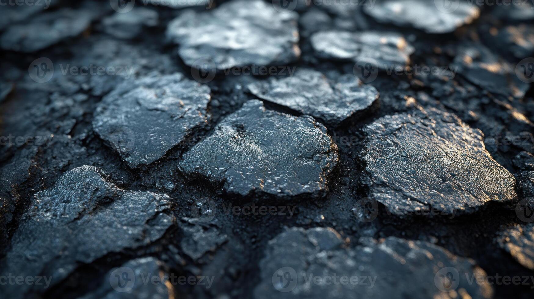 Close-up of textured, dark surface with cracks. photo