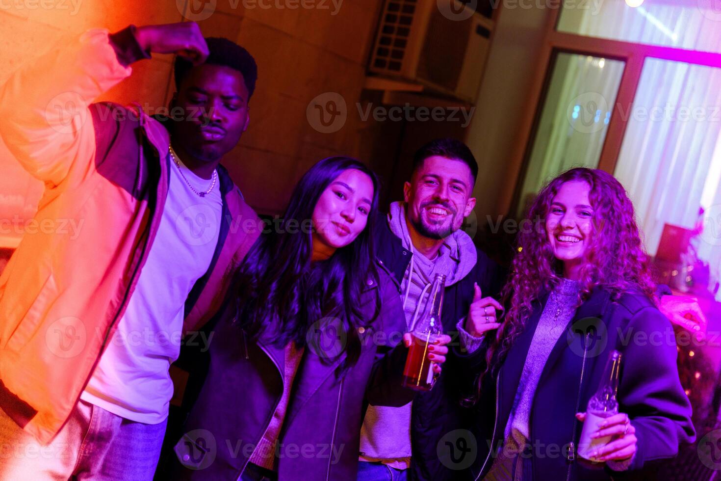 Friends enjoying a lively night out at a modern lounge with colorful lighting in the background photo