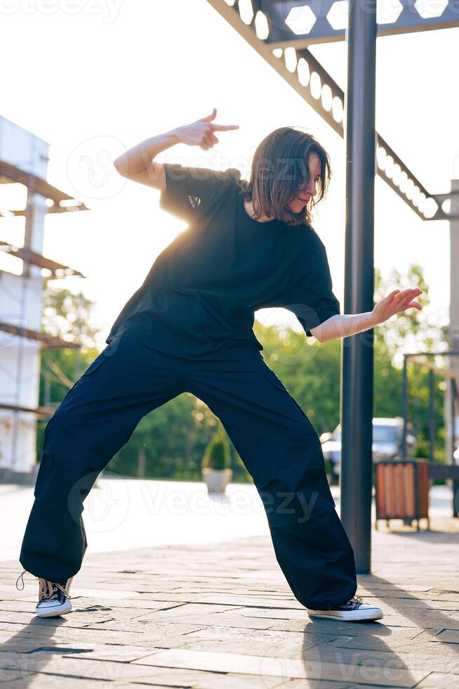 Dance performance in urban setting during golden hour with stylistic movements photo