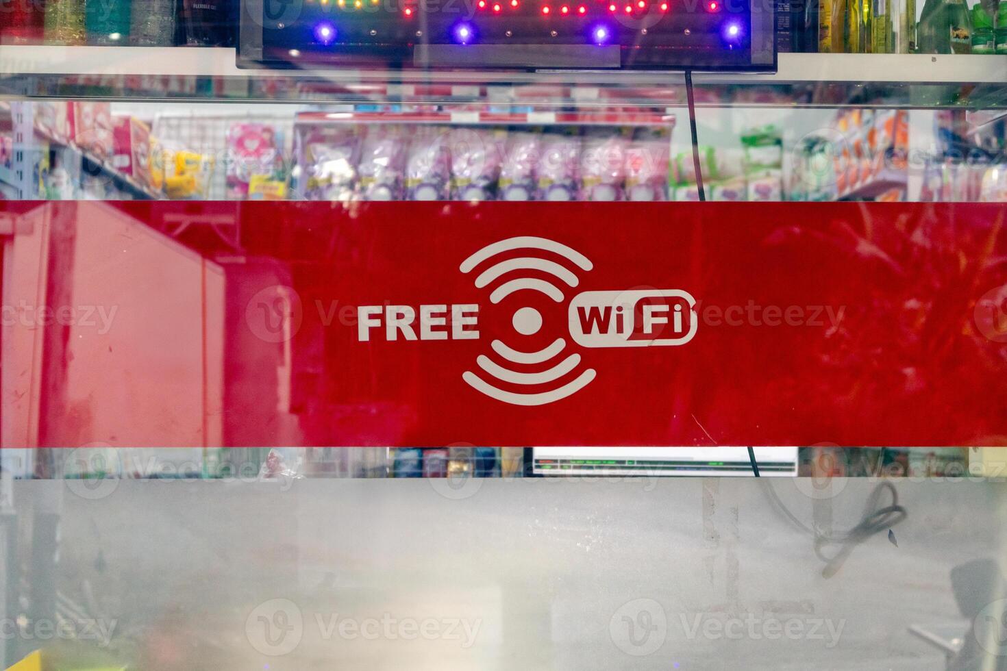 Free wifi icon symbol on the glass door of a grocery store photo
