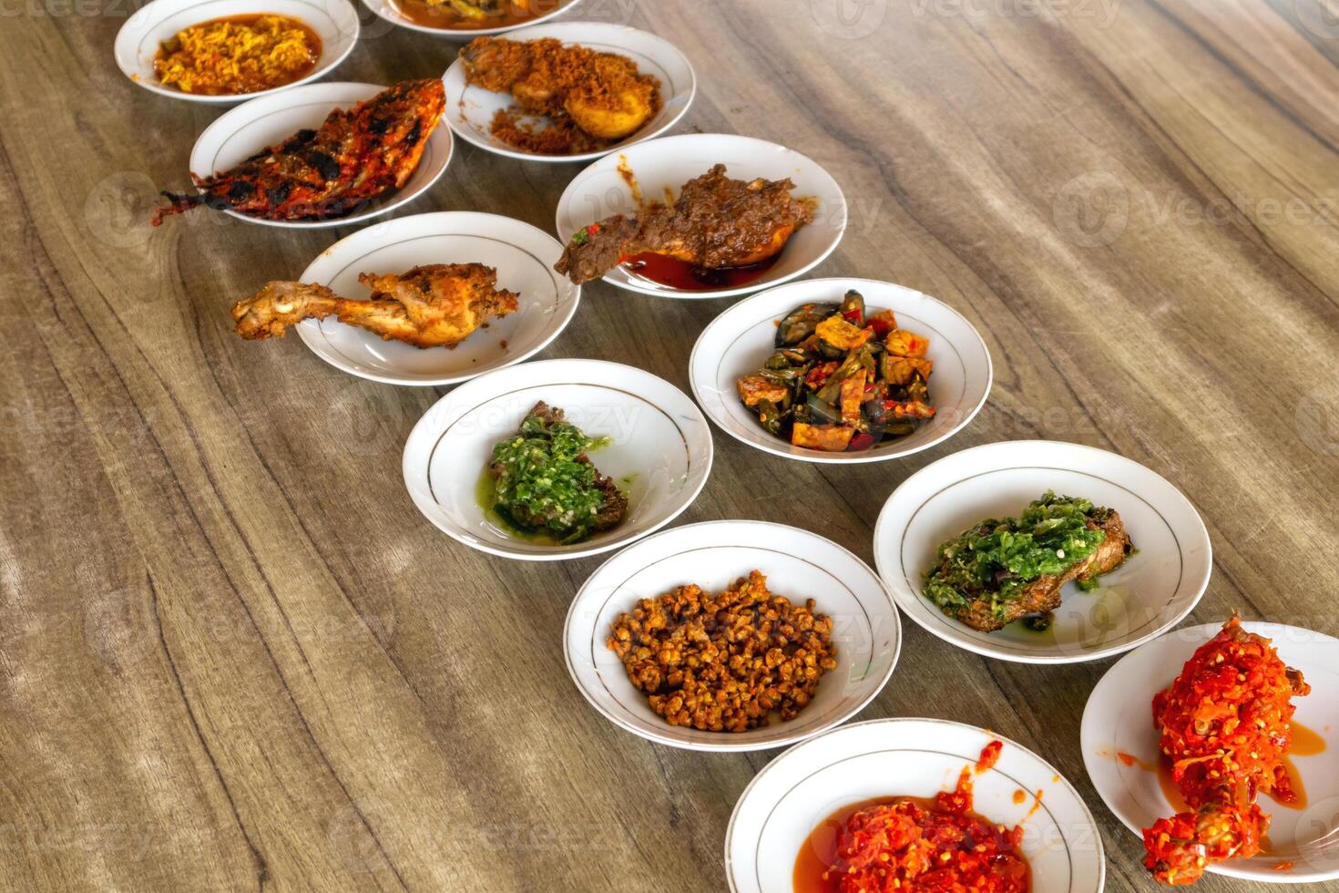 Typical Minangkabau food served on a table in a restaurant photo