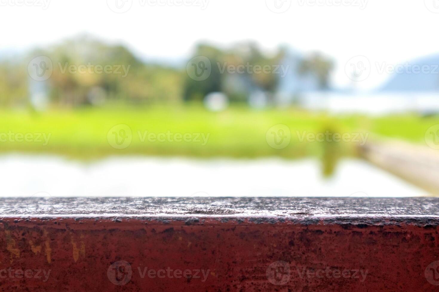 Wooden base with blurred background of natural scenery of rice fields and hills photo
