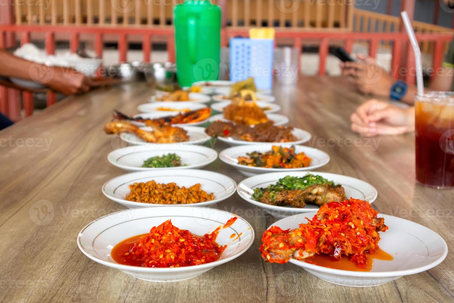 Side dishes on plates served on the table. Typical Minangkabau cuisine. photo