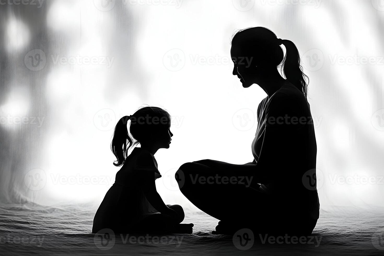 A woman and a child sitting in the dark photo