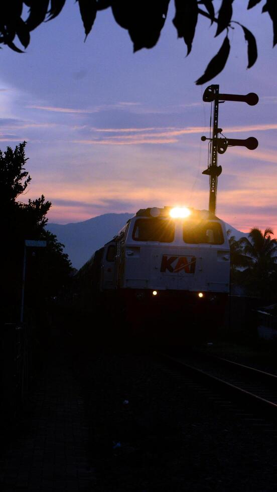 3. 11 August 2024, View of a train passing through the countryside with natural scenery photo