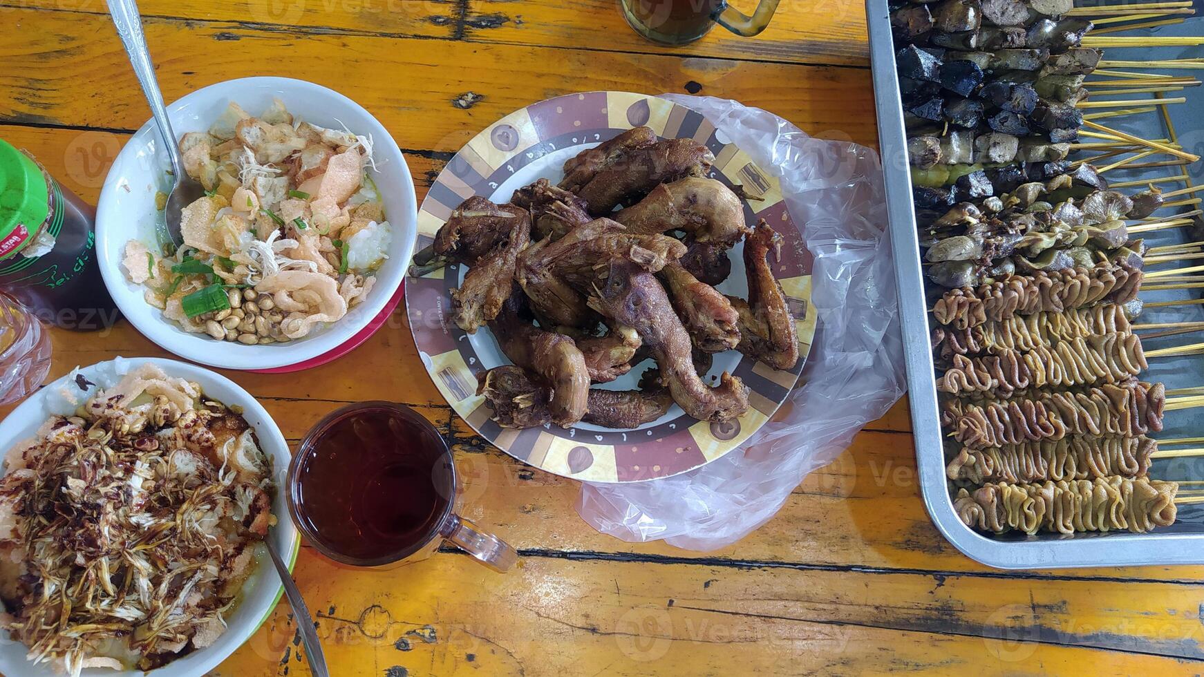 2 Chicken porridge on the table with satay photo