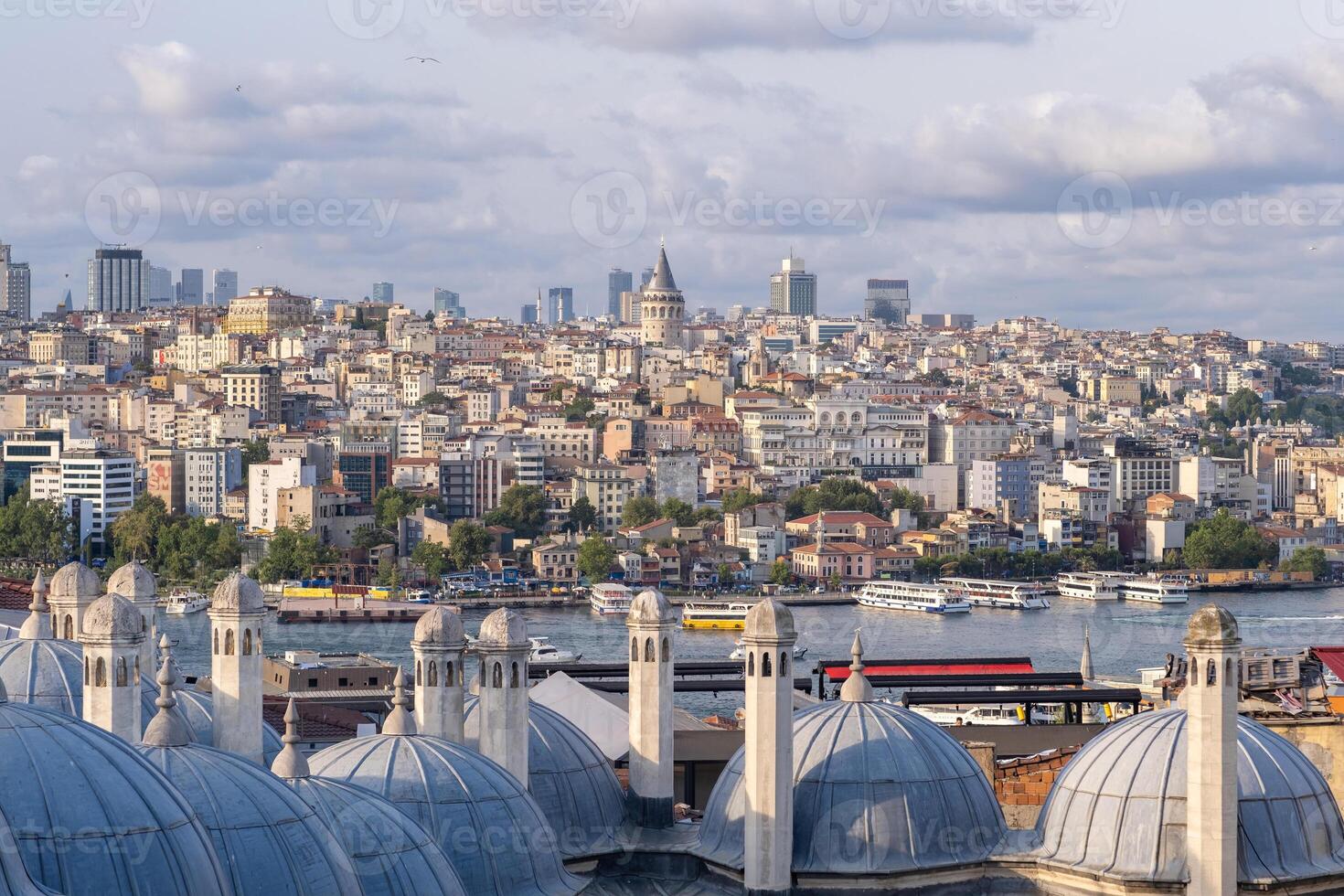 The skyline of Istanbul is visible with the Bosphorus River, Galata Tower, photo