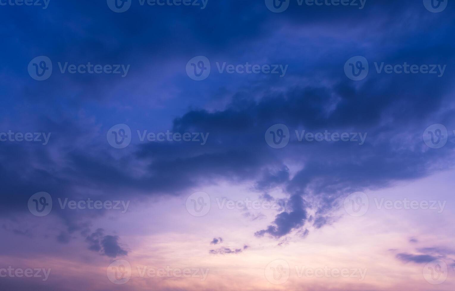 A captivating image of a deep blue sky, highlighted by soft, hazy clouds at sunset. photo
