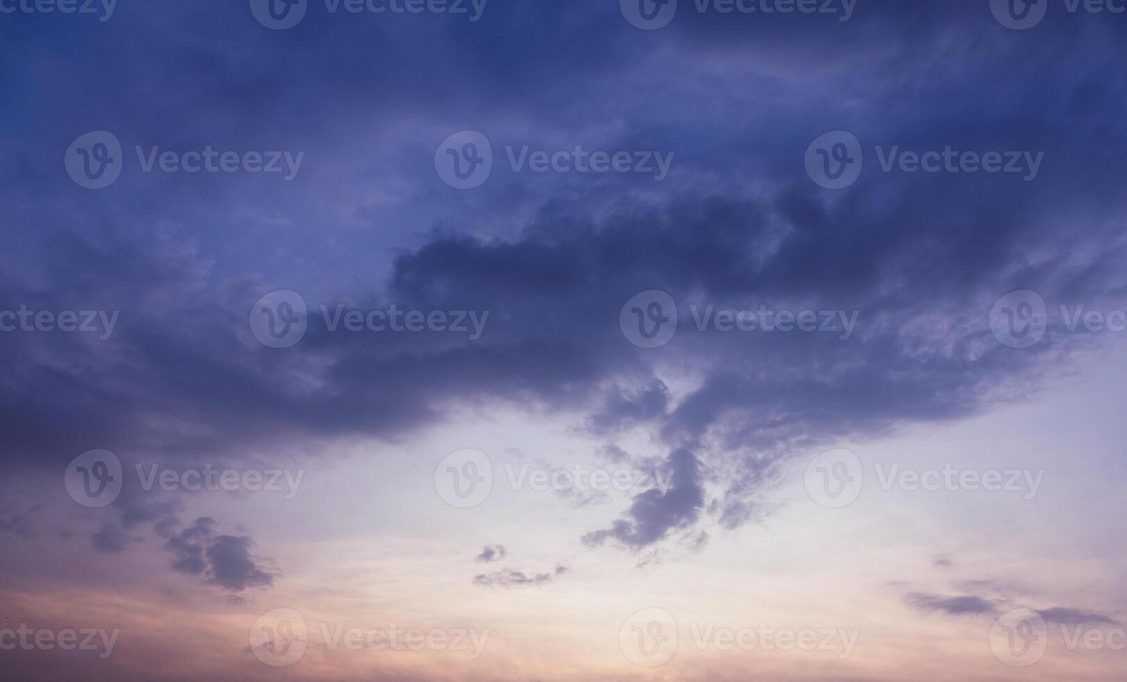 A captivating image of a vibrant sunset sky transitioning from warm orange hues to deep blue. photo