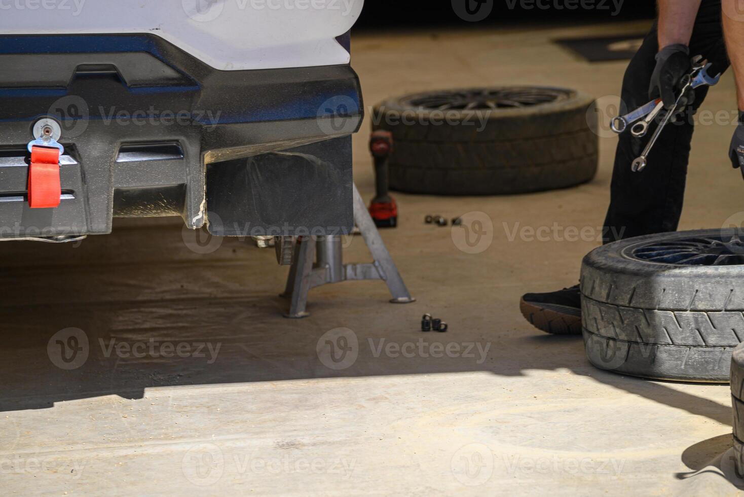 Race car maintenance in pit stop with tools mechanic working on photo