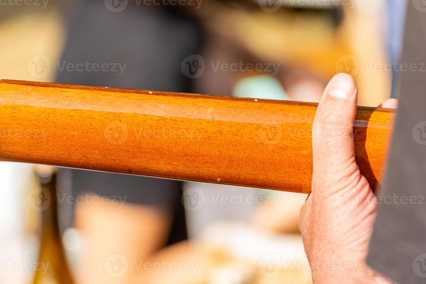 Close up of hands playing acoustic guitar fretboard Fingers forming chord on steel string acoustic guitar photo