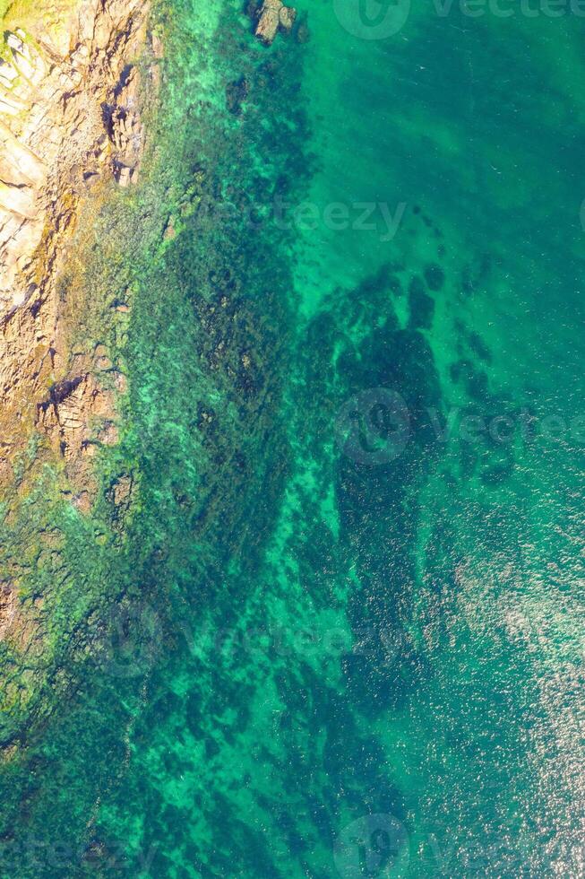 drone shot of sandy beach merging with rocky ocean floor. Aerial drone overhead view photo