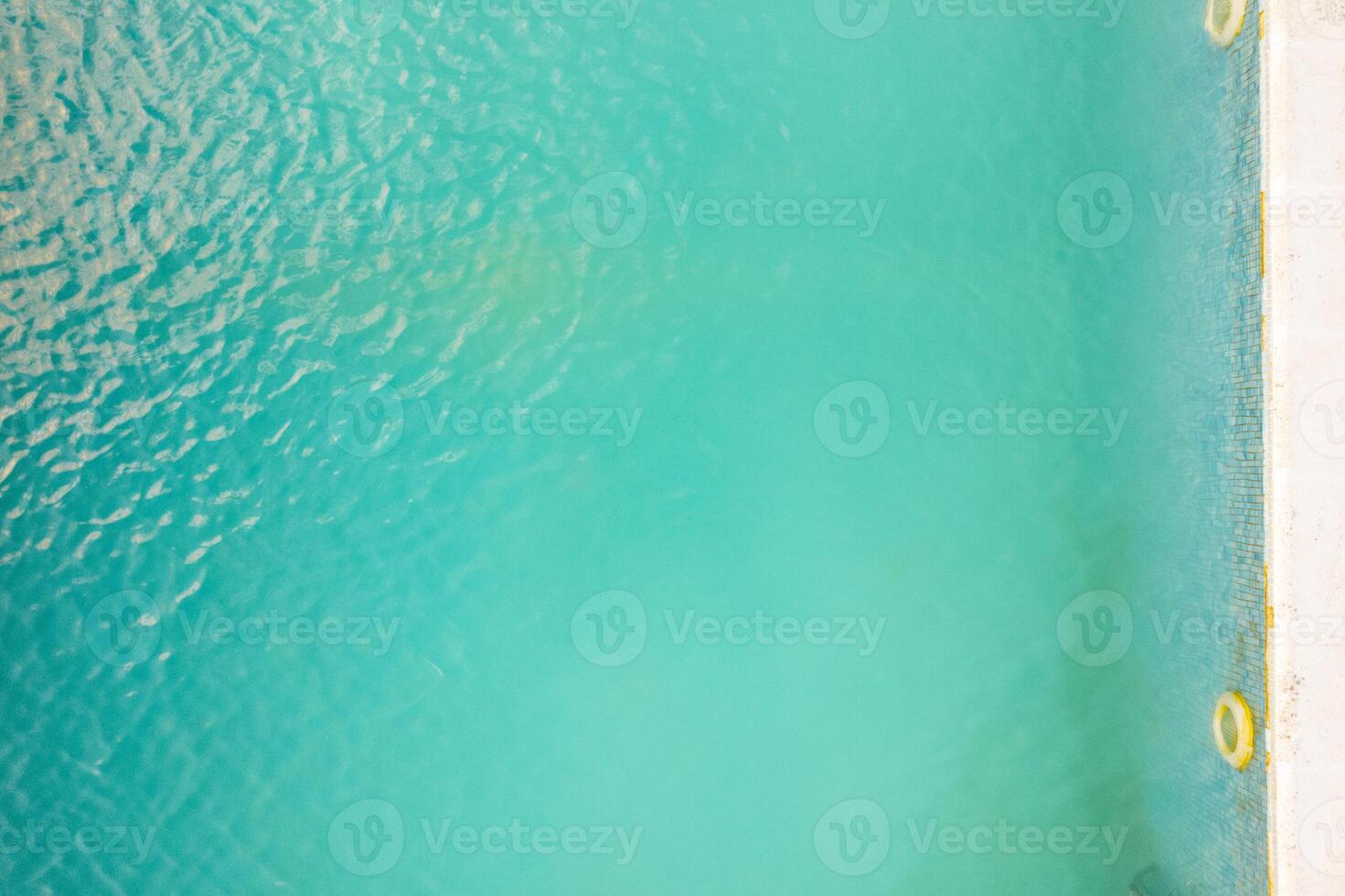 aerial top down view of clear pool water, turquoise swimming pool water texture photo