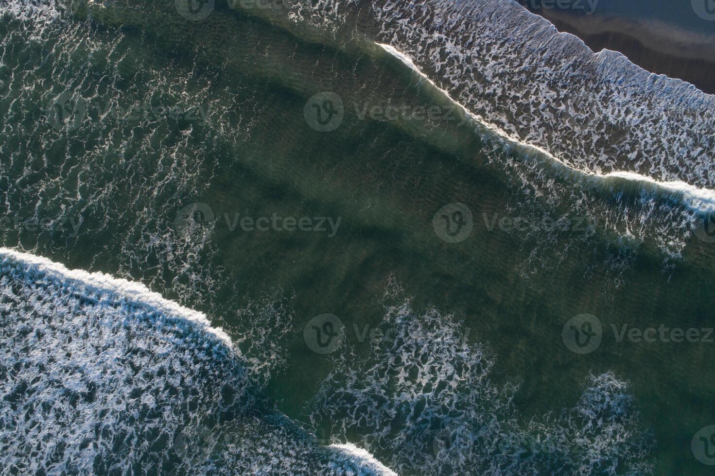 drone aerial directly above view of the waves on the shore of a beach on a day of high tides photo
