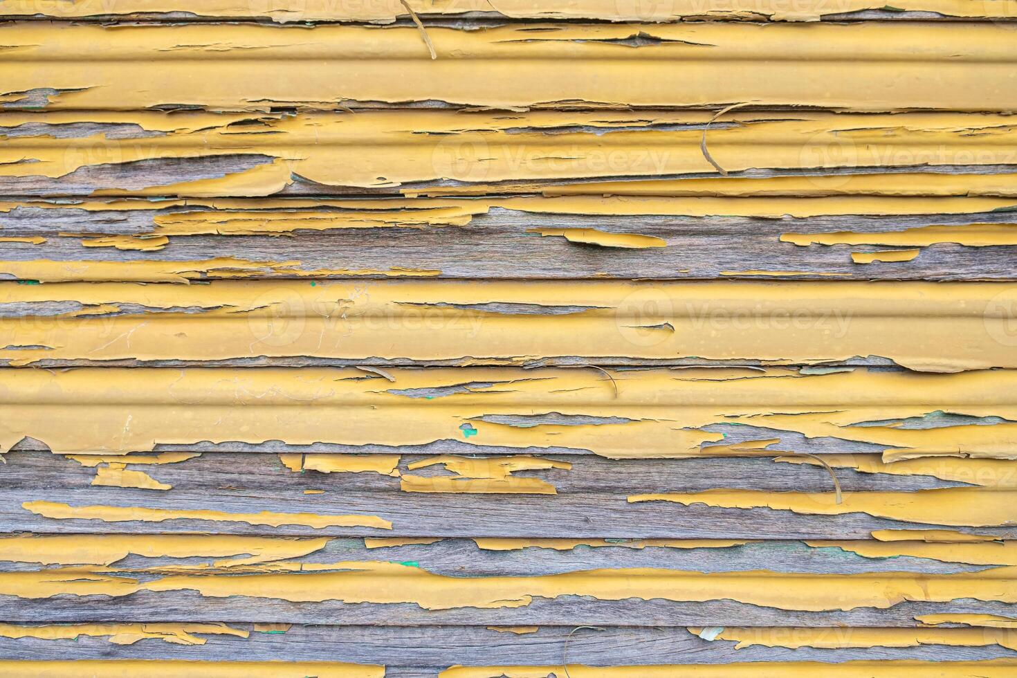 rustic yellow wood with layers of peeling paint, textured wooden fence close up photo