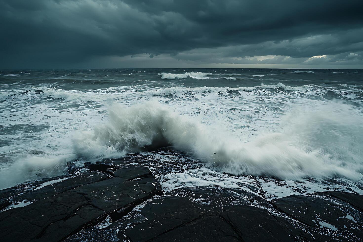 Dramatic Ocean Waves Crashing on Dark Rocks Under a Stormy Sky. photo
