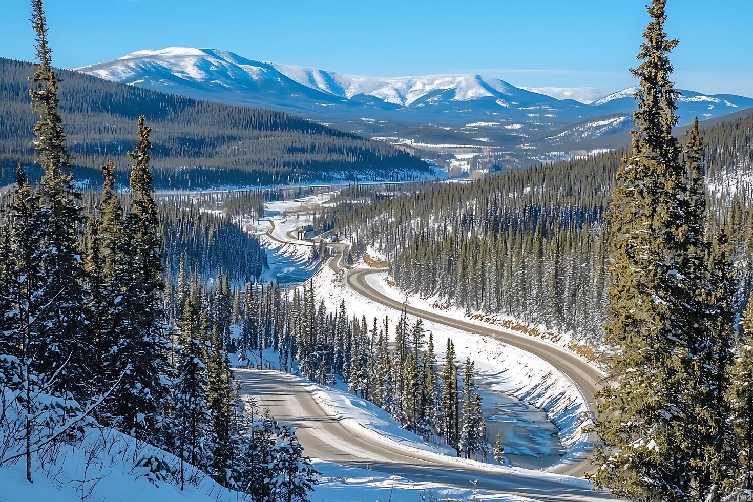 Scenic Winter Highway Winding Through Snow Covered Mountains and Evergreen Trees. photo