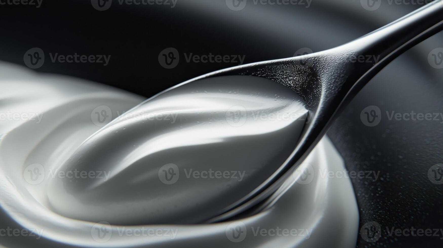 Natural yogurt on spoon, soft cream texture, top view photo