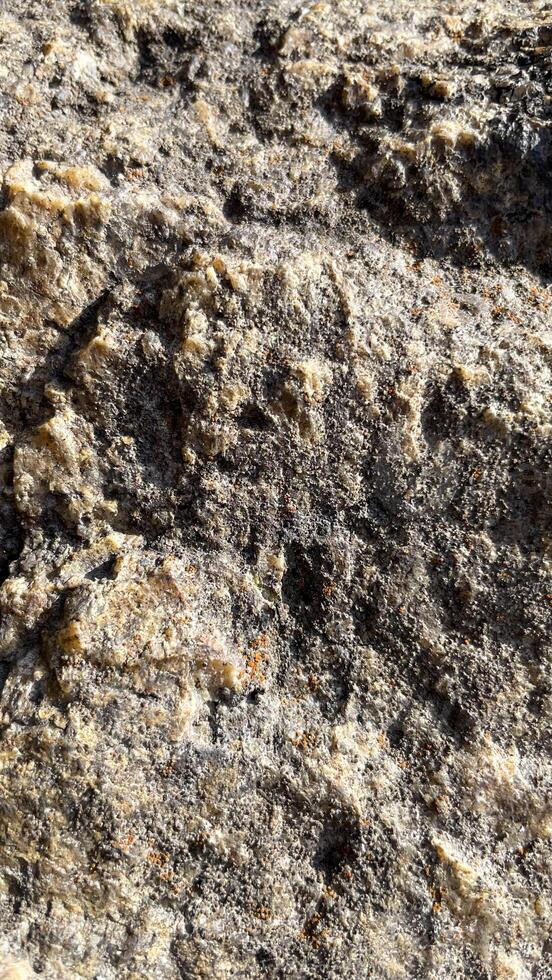 The stone is textured. Background photo