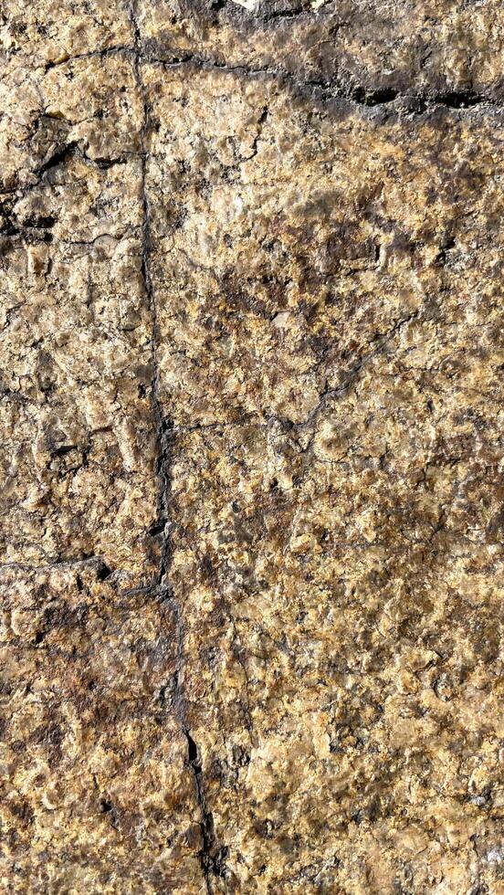 Grey stone wall with cracks. Texture Background. photo