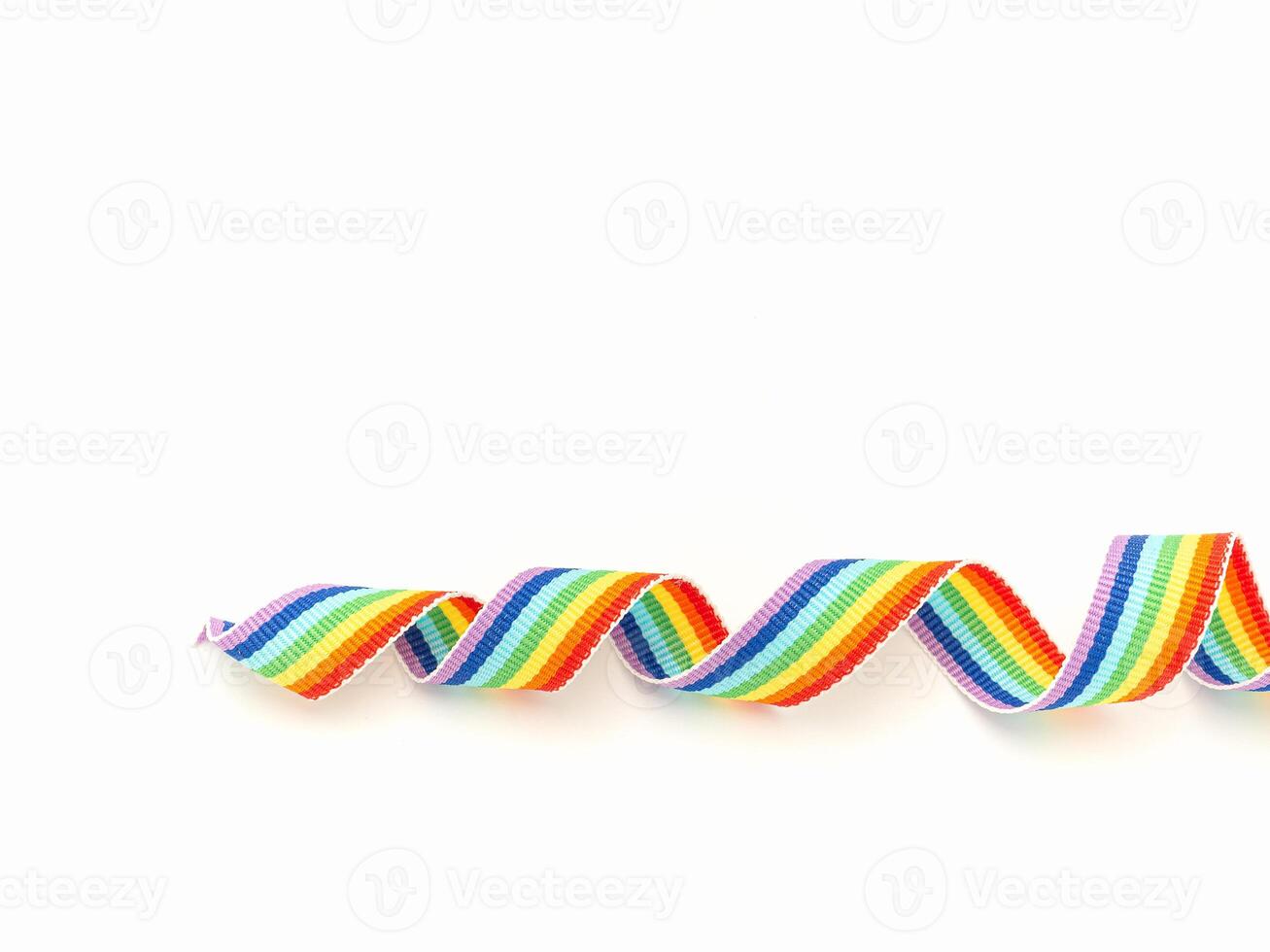 Top view of a rainbow cloth ribbon on a white background. Space for text. photo