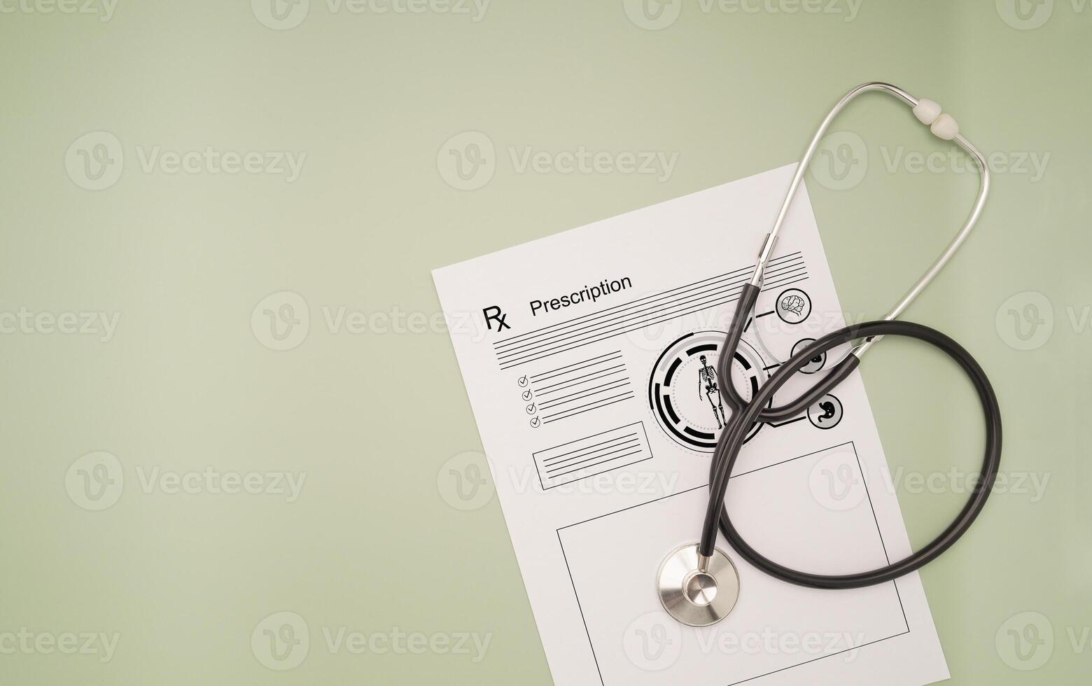 Top view of a stethoscope over the medical prescription sheet on a green background photo