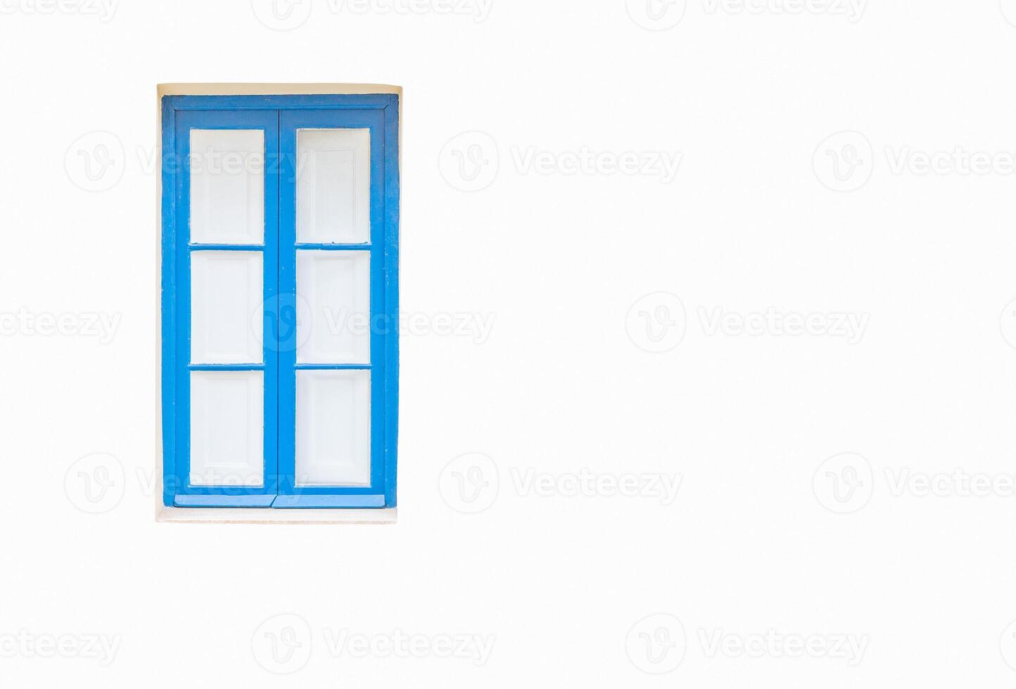 White wall with a turquoise window and white curtains behind it photo