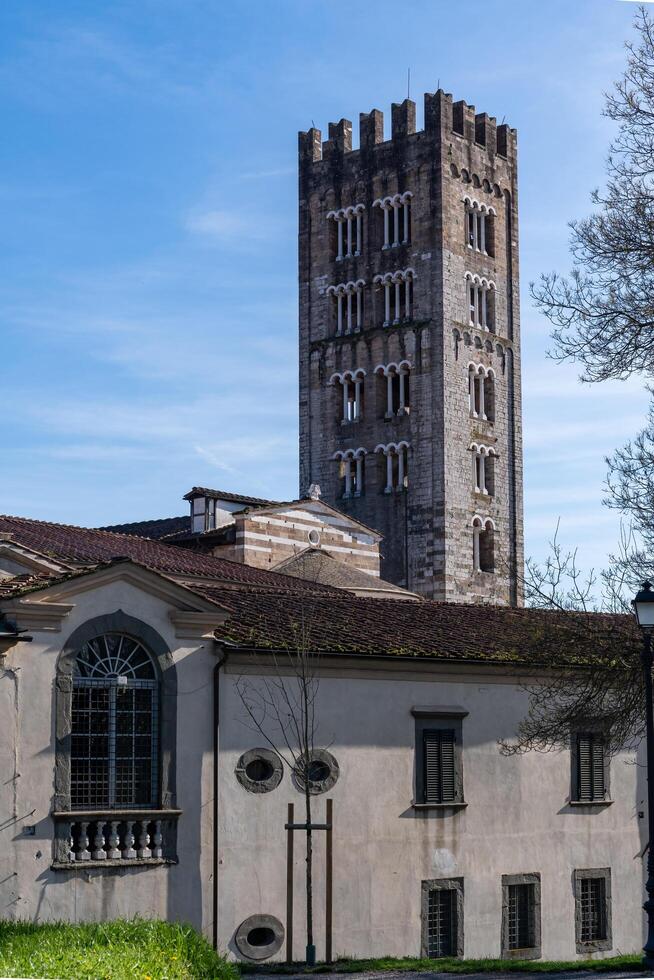 Lucca, Italy-February 16, 2025-vertical photograph of the bell tower of the Basilica of San Frediano during a sunny day photo