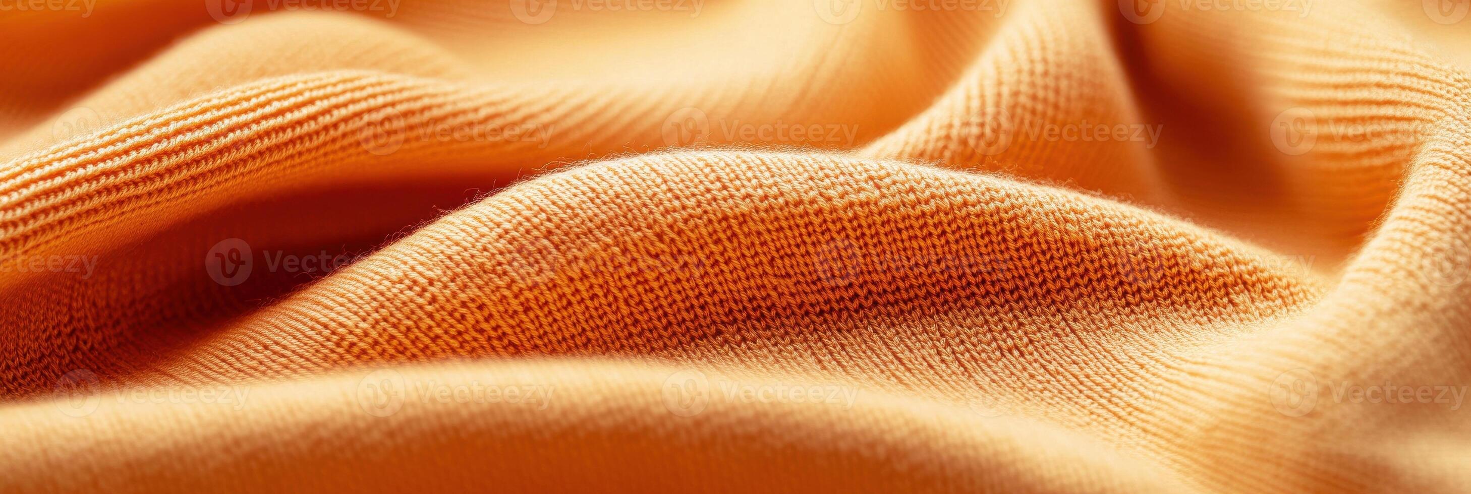 Close-up of orange textile fabric displaying texture and pattern for design concepts photo