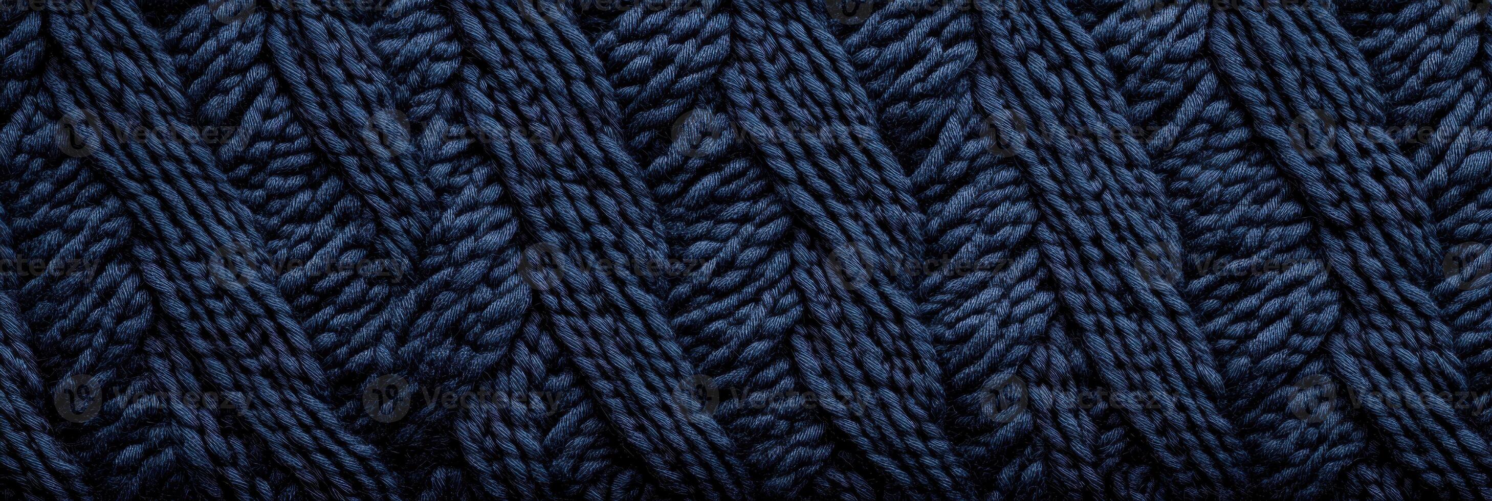 Close-up of intricate blue yarn knitting pattern displaying textured fabric design photo