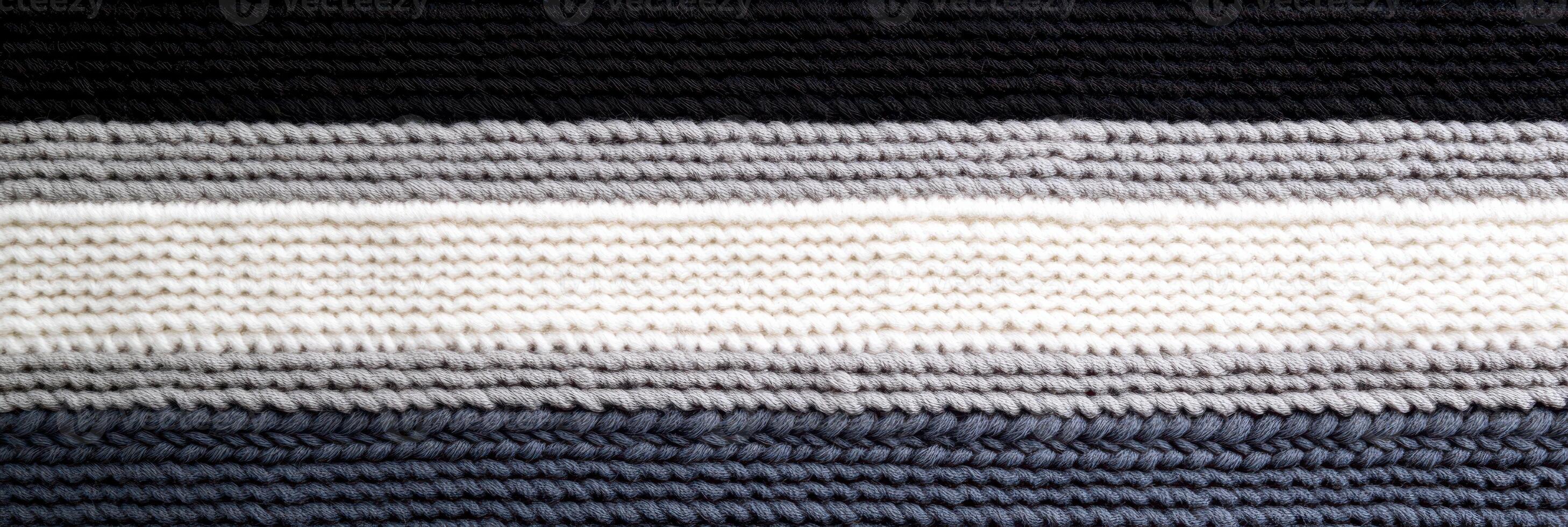 Striped knitted textile with multiple gray and black horizontal layers photo