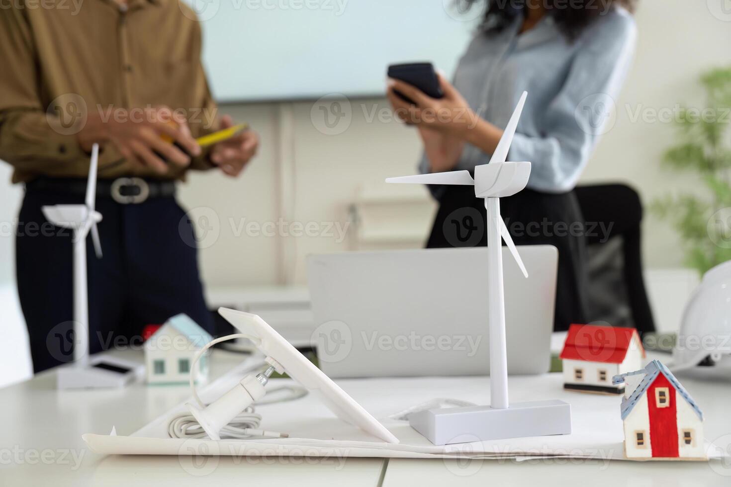 Sustainable Energy and Collaborative Innovation. Professionals discussing renewable energy solutions in a modern workspace. photo