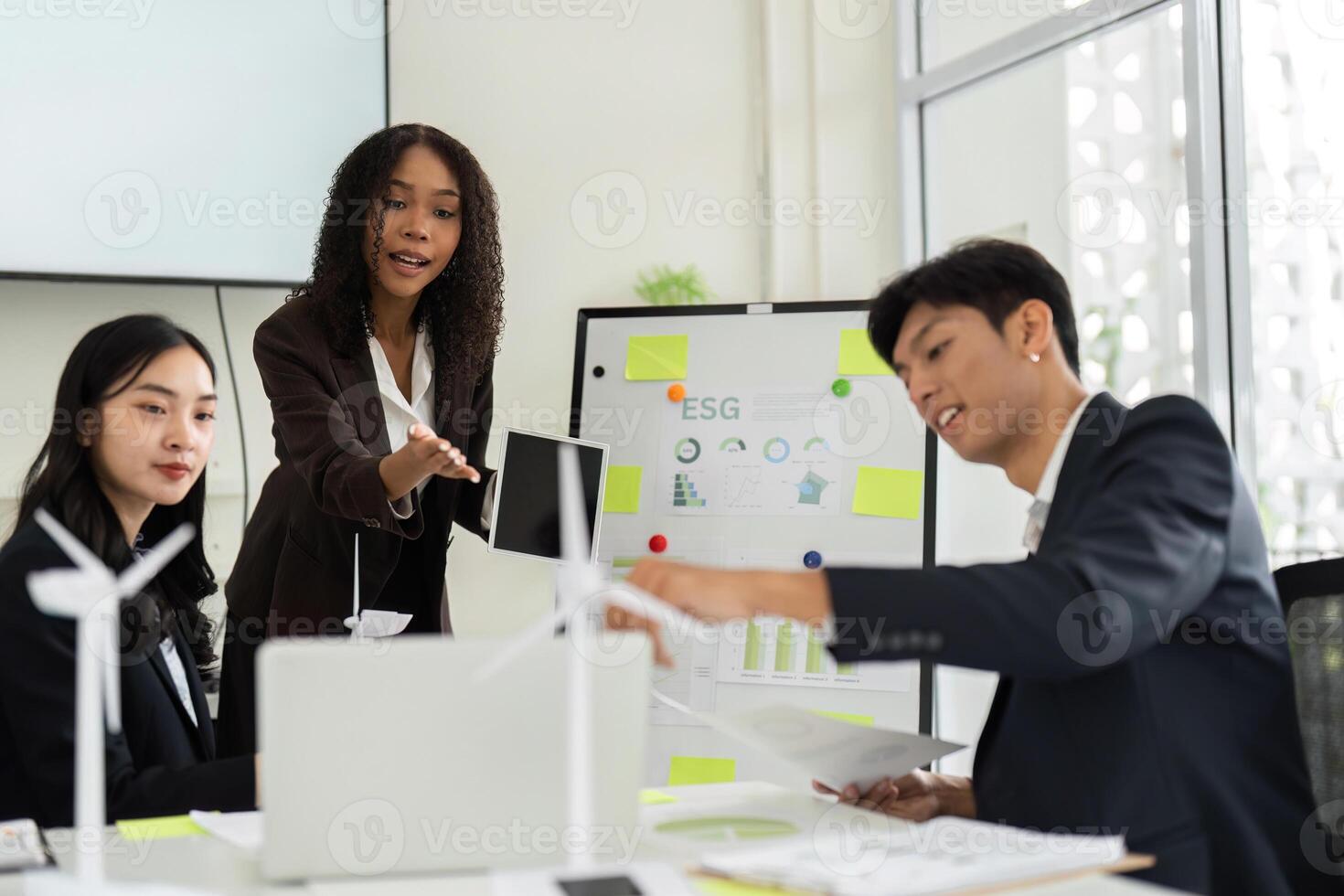 Collaborative ESG Discussion in a Corporate Environment. A team engages in brainstorming innovative solutions for sustainable practices. photo