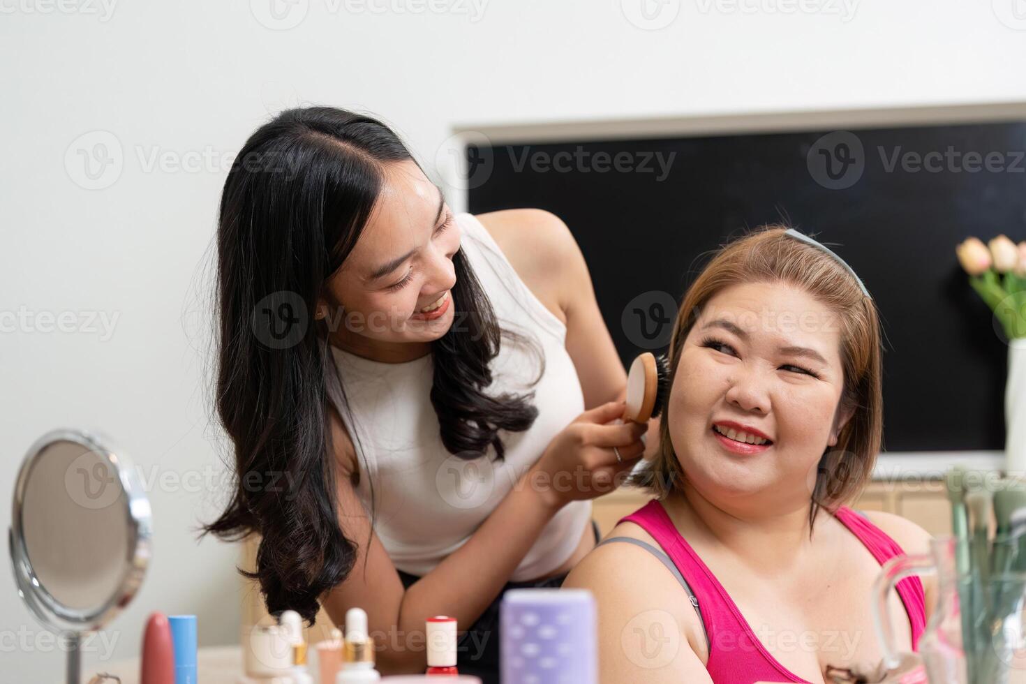 Beauty Consultation and Friendship. A woman enjoys a beauty treatment while sharing laughter with her friend at a cozy area. photo