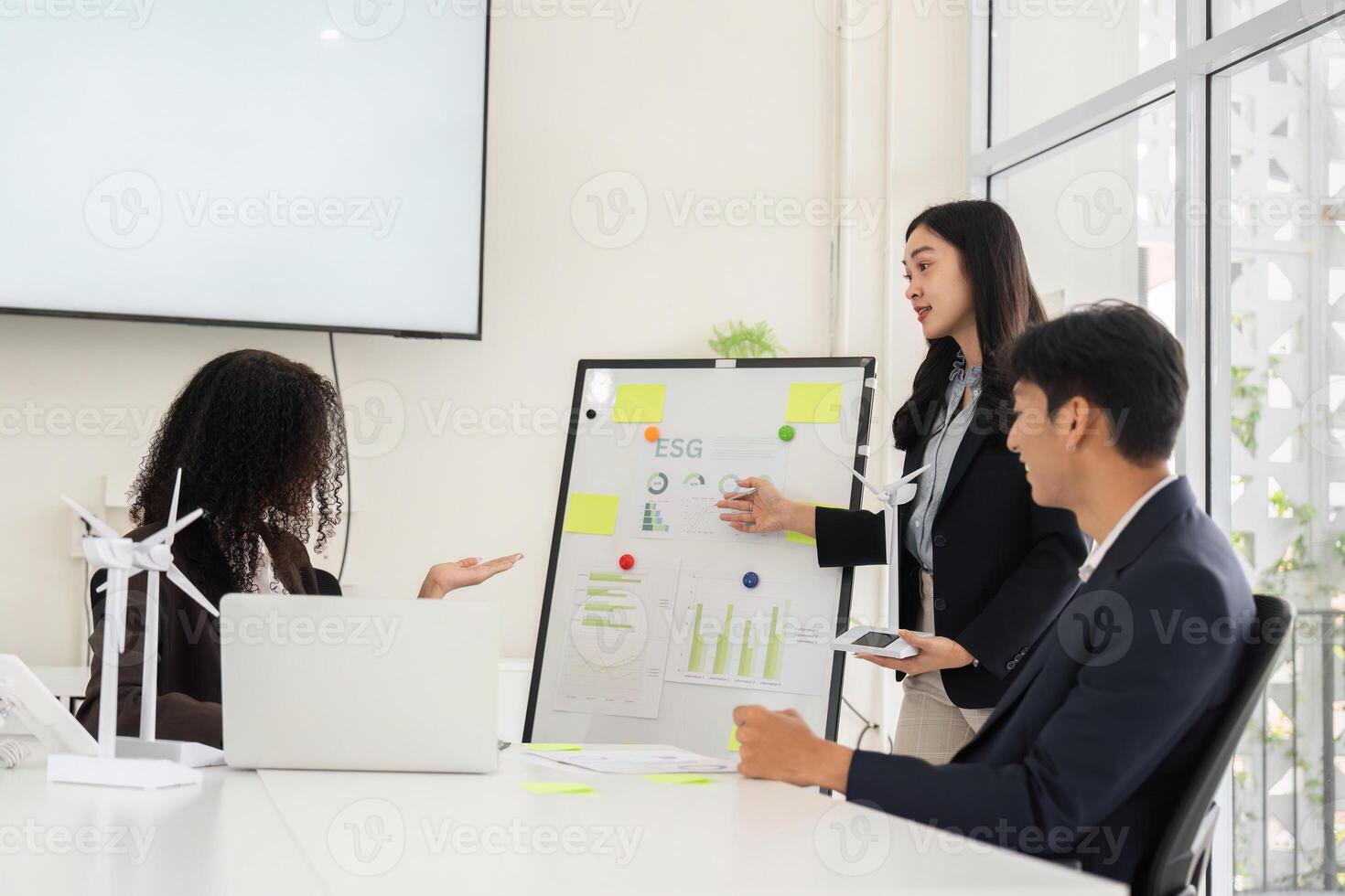 Strategy Presentation and Environmental Advocacy. A professional highlights ESG data insights in a team meeting. photo