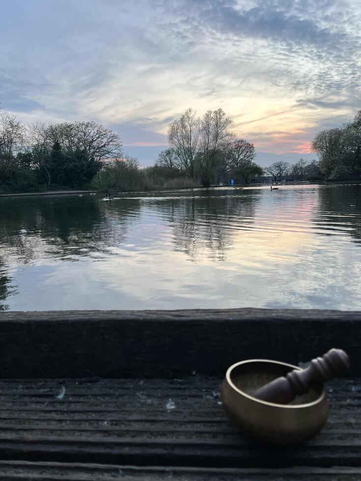 Mindful meditation with a singing bowl by the lake photo