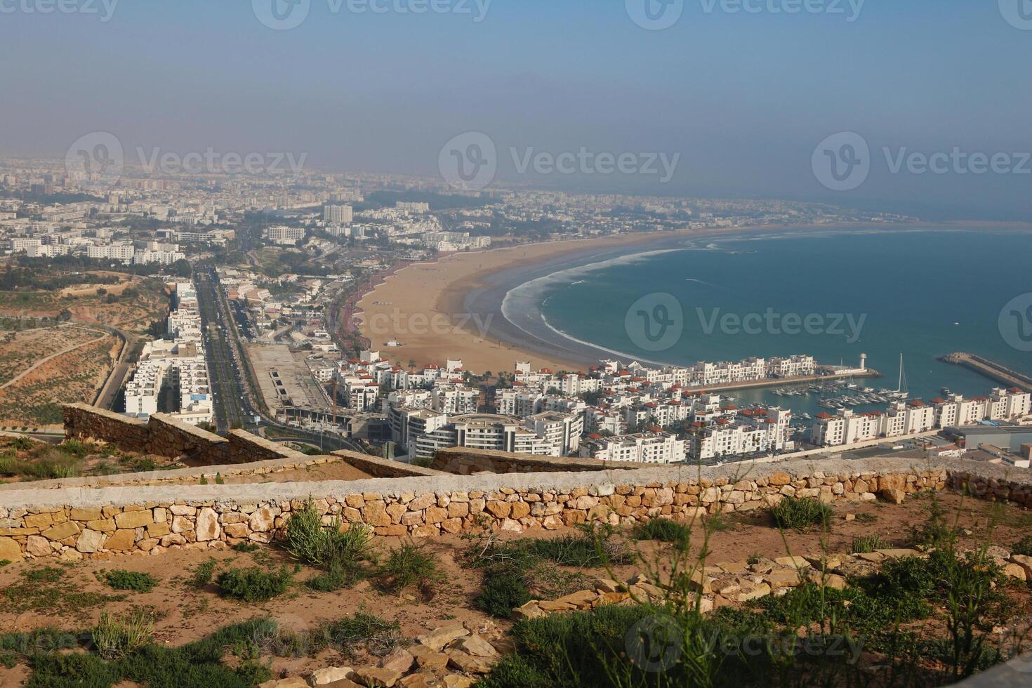 Aerial view of Agadir beach and Agadir port, coastal cityscape in Morocco photo