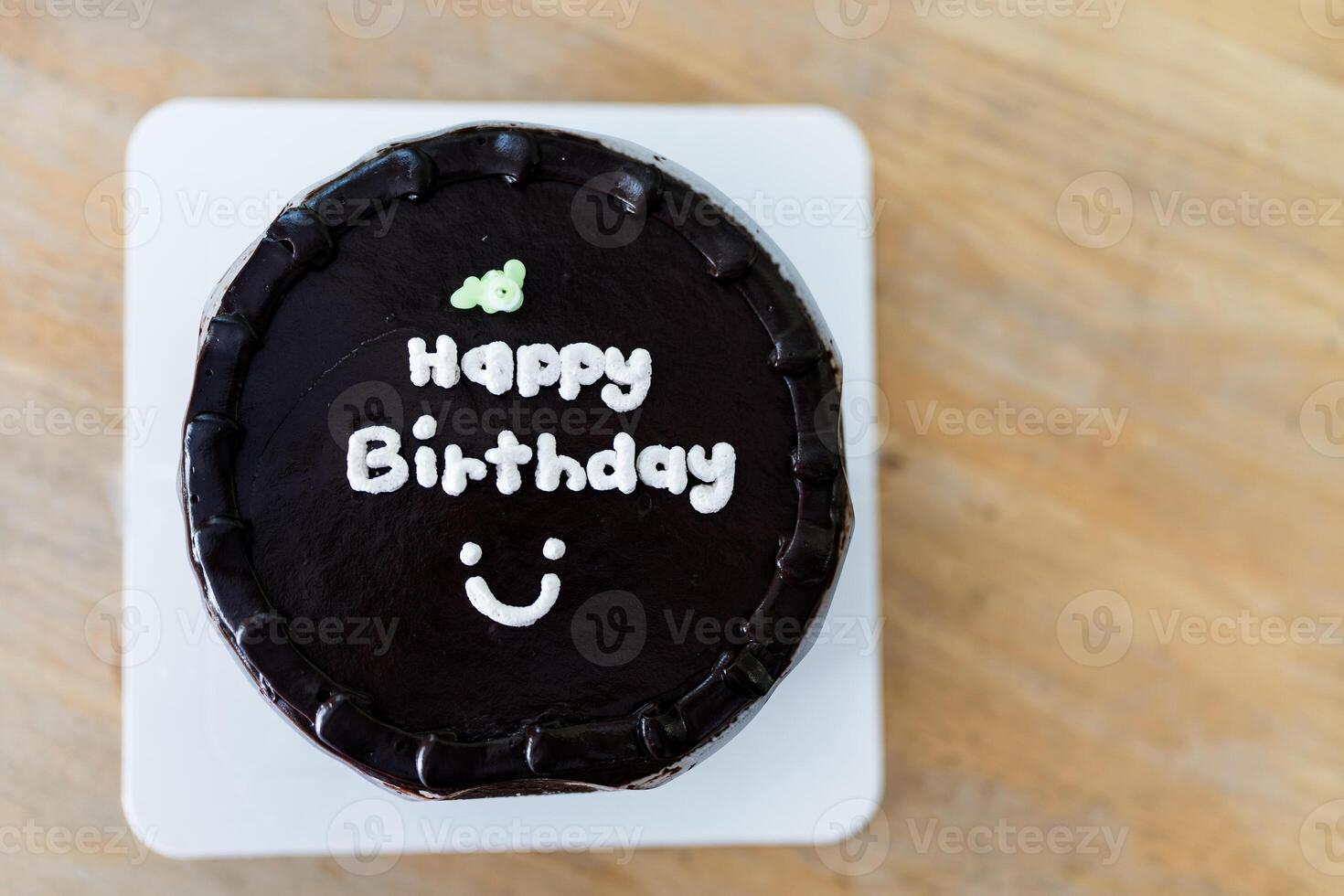 Chocolate cake with message saying Happy Birthday and smile symbol photo