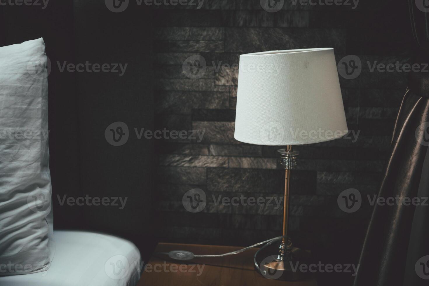 Classic table lamp standing on the bedside table photo